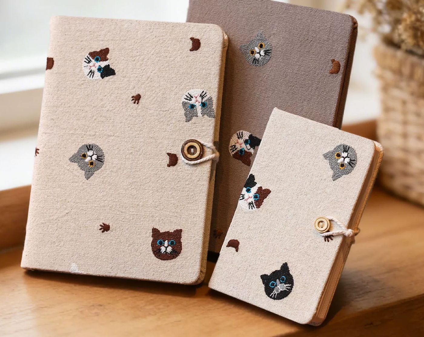 Embroidered fabric notebooks with a coconut-shell button